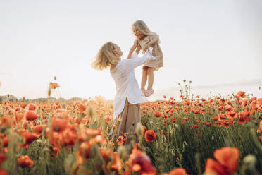 Happy mother lifting daughter in air - SIF00198