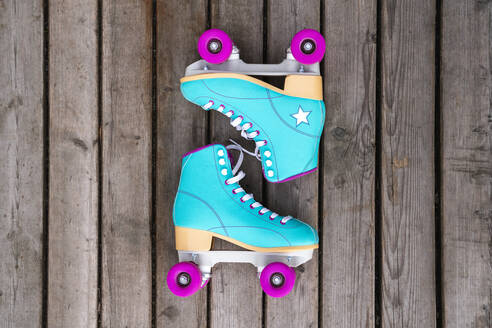 Multi colored roller skates on floorboard - VPIF06604