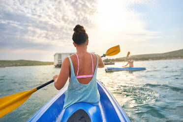 Couple kayaking on sunny summer lake - CAIF33351