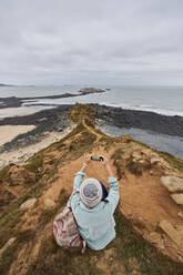 From above anonymous woman taking a picture of the landscape - ADSF35322