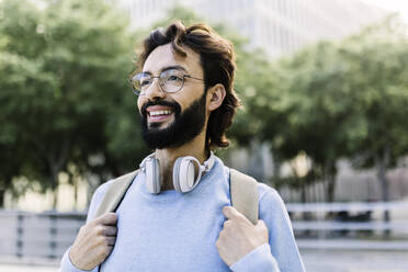 Smiling bearded man with wireless headphones - XLGF02982