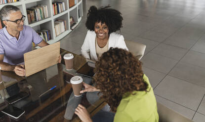 Happy business colleagues sitting together in office - JCICF00206