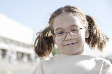 Smiling girl with pigtails wearing eyeglasses - EYAF01967