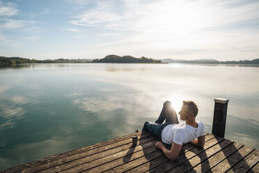 Mature man looking at scenic view from pier - DIGF18129