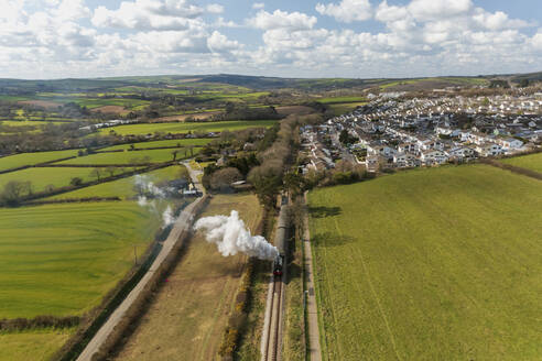 Aerial view of Bodmin and Wenford Steam train travelling from Boscarne Junction Station heading to Bodmin General Station, Cornwall, United Kingdom. - AAEF14708