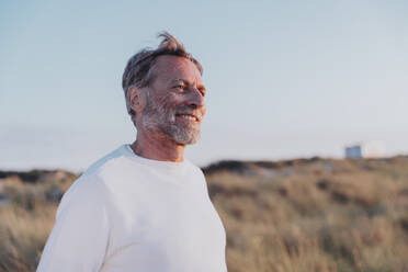 Happy man standing in front of sky - MFF09161