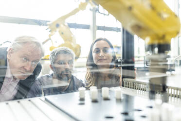 Technicians testing and observing new industrial robot - WESTF24873