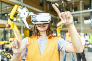 Industrial worker in robotics factory using virtual reality simulator - WESTF24921