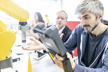 Industrial engineer working at industrial robot using digital control - WESTF24953