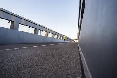 Man jogging on footbridge - DIGF18193