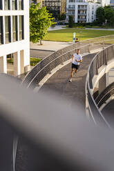 Man jogging on elevated walkway - DIGF18205