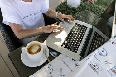 Freelancer working on laptop at table - SIF00215