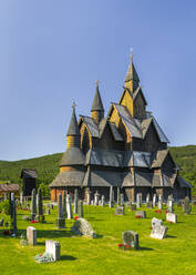 Norway, Vestfold og Telemark, Heddal, Tombstones in front of medieval stave church in summer - STSF03289