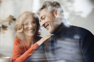 Happy couple in cafe seen through glass - JOSEF10846