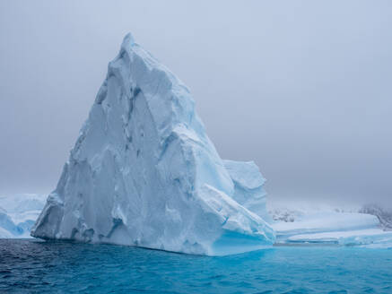 A huge iceberg grounded on a reef near the Iceberg Graveyard, Petermann Island, Antarctica, Polar Regions - RHPLF22102