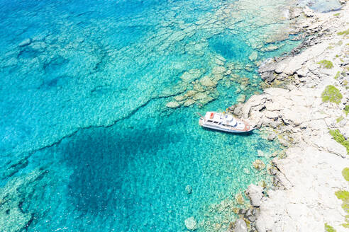 Aerial view of yacht moored in the crystal clear sea, Crete island, Greek Islands, Greece, Europe - RHPLF22141
