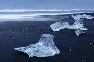 Eisberge vom schmelzenden Gletscher am schwarzen Sandstrand in der Nähe der Gletscherlagune Jokulsarlon, Vatnajokull-Nationalpark, Island - RHPLF22183