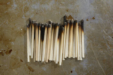 Studio shot of row of burned matches - AXF00867