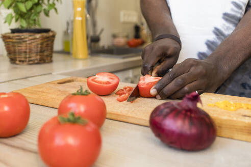 Hände eines Mannes beim Schneiden von Tomaten in der Küche - OSF00281