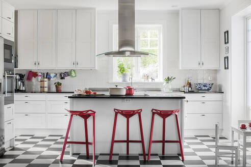 Red stools at kitchen bar - FOLF11615