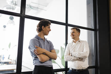 Young businessman talking with colleague in office - DCRF01333