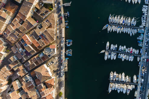 Aerial view of sailing boats anchored along the river in Martigues at sunset, Provence, France. - AAEF14872