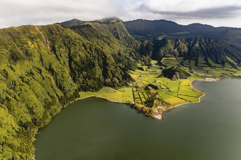 Aerial View of fields grown along the coast of the lake Lagoa Verde, Sete Cidades, Azores, Portugal. - AAEF14932