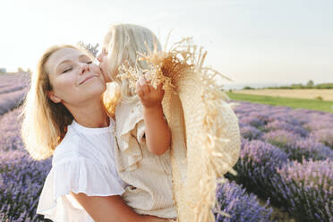 Girl with hat kissing mother at lavender field - SIF00297