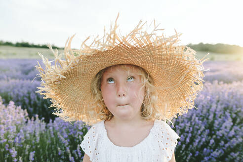Girl wearing hat making face in lavender field - SIF00303