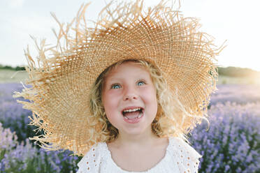 Cheerful girl wearing hat in field at sunset - SIF00304