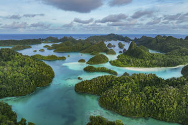 Luftaufnahme von verstreuten Inseln mit blauem Meerwasser auf der Insel Wajag, Raja Ampat, West Papua, Indonesien. - AAEF14971