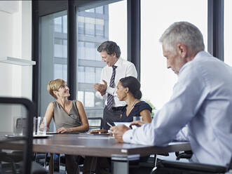 Happy business colleagues having meeting in board room - RORF02931