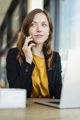 Contemplative businesswoman talking on smart phone - DIGF18234