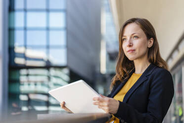 Contemplative businesswoman holding tablet PC - DIGF18254