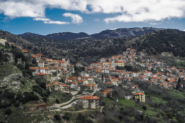 Greek village mountain view panorama with traditional low-rise houses with red roof tiles in Dimitsana, Arcadia, Peloponnese, Greece, Europe - RHPLF22478