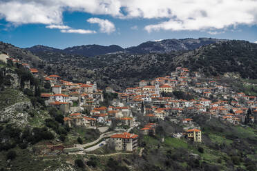 Griechisches Dorf mit Bergpanorama und traditionellen niedrigen Häusern mit roten Dachziegeln in Dimitsana, Arkadien, Peloponnes, Griechenland, Europa - RHPLF22478