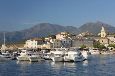 View across harbour to the town and citadel, hills of the Cap Corse peninsula beyond, St-Florent, Haute-Corse, Corsica, France, Mediterranean, Europe - RHPLF22489