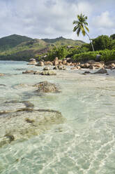 Seychelles, Praslin, Boulders lying along tropical beach - RORF02943