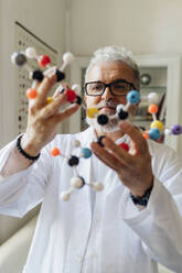 Scientist examining molecular structure in lab - MEUF07179