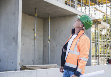 Senior contractor examining construction site - UUF26845