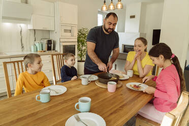 Mann serviert der Familie zu Hause das Frühstück - OSF00412