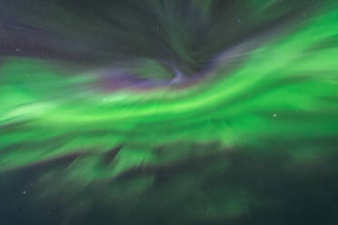 Spectacular scenery of green Northern lights illuminating dark sky in winter - ADSF36062