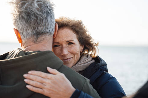 Smiling mature woman embracing man - JOSEF11378