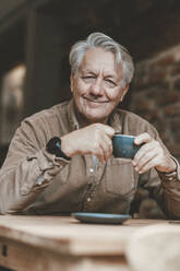 Smiling senior man having coffee in cafe - JOSEF11569