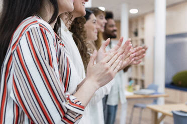 Business team clapping hands after a presentation in office - PNAF04270