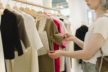 Woman shopping at clothes store - SEAF01110