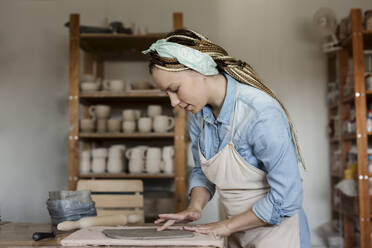 Potter working in art studio - LLUF00772