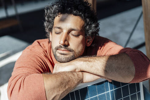 Businessman with solar panel and sunlight at workplace - JOSEF11806