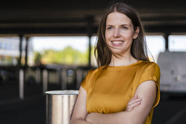 Thoughtful smiling businesswoman with arms crossed - DIGF18507