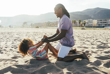 Vater spielt mit Tochter am Strand - OIPF02233